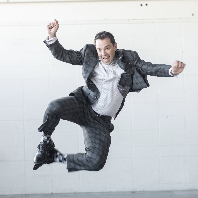 Jumping man in a suit